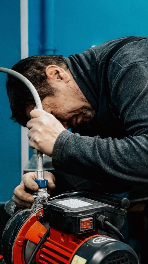 Technician adjusting water pump
