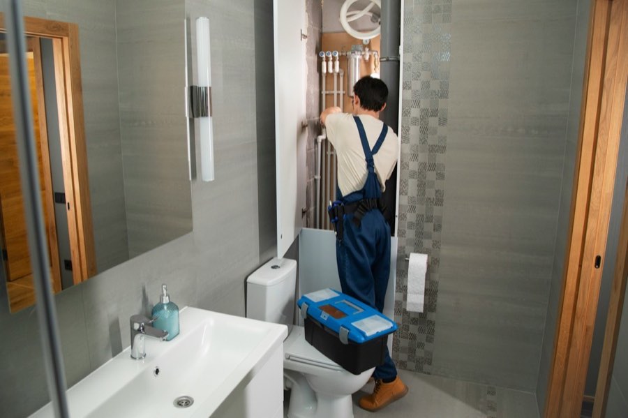 Plumber in bathroom